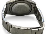 a close up of a watch on a white surface