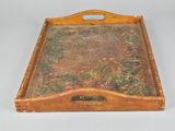 a wooden tray with a painting on it on a table