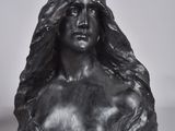 black and white photograph of a busturine of a woman wearing a headdress