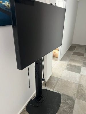 a flat screen tv on a stand in the corner of a room