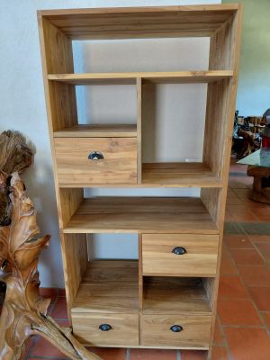 a wooden shelf with drawers on it in a room