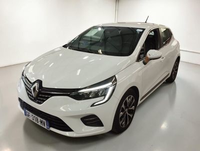 La voiture blanche est garée dans une pièce blanche au sol blanc.
