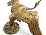 bronze statue of a bird on a pedestal on a white background