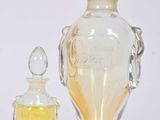 a small glass bottle and a small glass bottle next to each other
