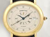 a gold wrist watch with a white dial and roman numerals