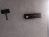 a remote control and a key on the wall