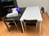 a table with two chairs and a box on the table