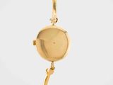 a close up of a watch on a gold bracelet on a white background