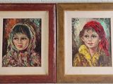 two paintings of a woman and a child are hanging on a wall