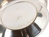 a silver vase that is sitting on a table