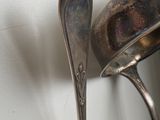 a silver spoon and spoon rest on a wall