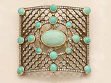 turquoise and diamond broochle set on a white background