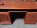 a wooden desk with two drawers and a drawer on top