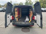 the back of a van with its doors open in a parking lot