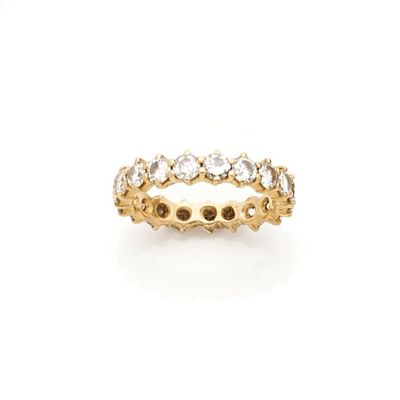 a yellow gold ring with white diamonds on a white background