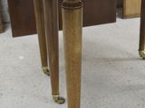 a wooden table with four legs and a wooden table top