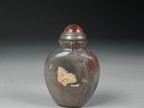 a small glass jar with a red lid on a table