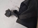 a person holding a black umbrella over a white table