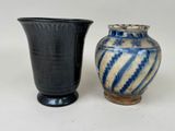 two vases sitting next to each other on a table