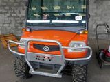 an orange utility vehicle parked in a parking lot