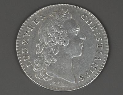 une vieille pièce d'argent portant une tête de femme