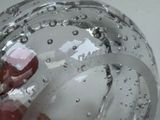 a hand that is holding a glass with water inside of it
