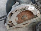 a circular saw sitting on the floor next to a tool box