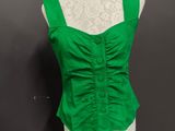 a close up of a green top on a mannequin mannequin