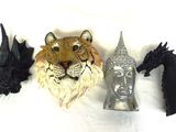 a tiger head, a dragon head, and a horse head on a white surface