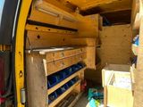 a yellow van that has a bunch of boxes inside of it