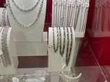 many necklaces and bracelets on display in a glass case