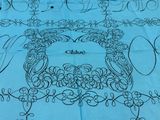 a blue table cloth with a picture of a bird on it
