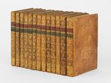 a set of six books with gold covers on them