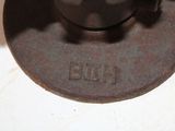 a black tea pot sitting on top of a metal plate