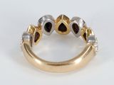 an image of a gold and silver ring with black diamonds