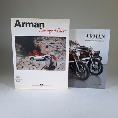 two books are sitting on a table next to a motorcycle