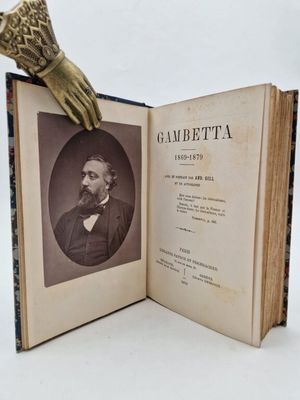 an old book with a picture of a man holding a glove on top of it