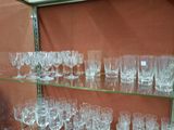 many glasses on a glass shelf in a room