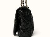 a close up of a black purse on a white background