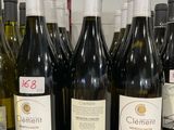 Des bouteilles de vin sont alignées sur le comptoir d'un caviste.