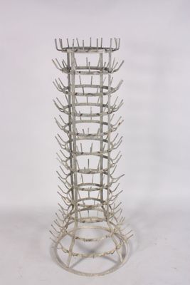 a tall metal wine rack with many bottles in it