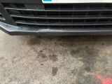 the front bumper of a car with a number plate on it
