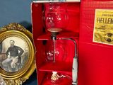 a red box with a picture of a man in a suit and a wine glass in it
