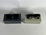 pair of black sunglasses in a black box on a white surface
