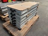 a stack of metal sheets on a pallet in a warehouse