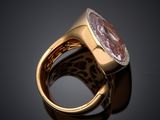 an image of a gold ring with a pink stone surrounded by diamonds