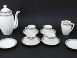 an image of a white tea set with blue and gold accents
