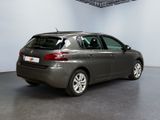the back of a grey car is parked in a room