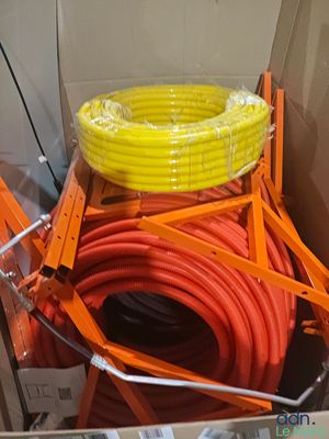a box with a bunch of orange and yellow hoses in it