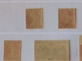 four different types of postage stamps are displayed on a piece of paper